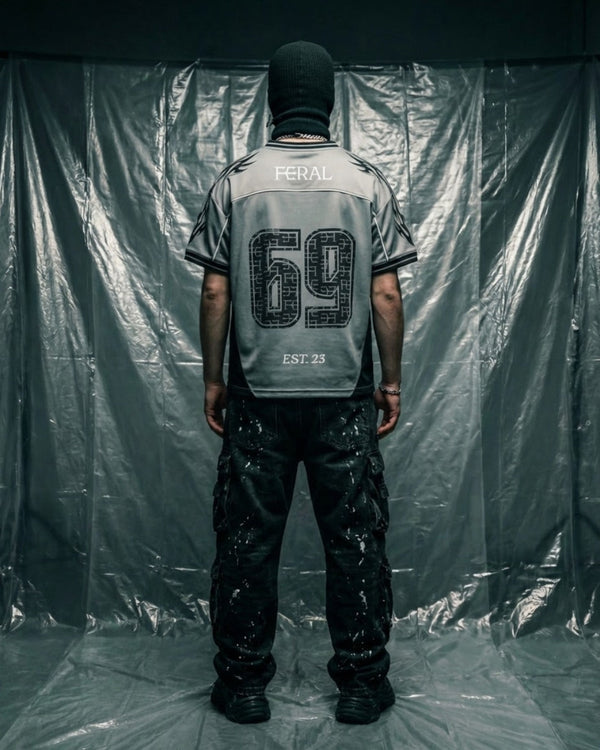 Men's rave outfits — model wearing FERAL Silver Haze Jersey, men's rave clothing and techno streetwear