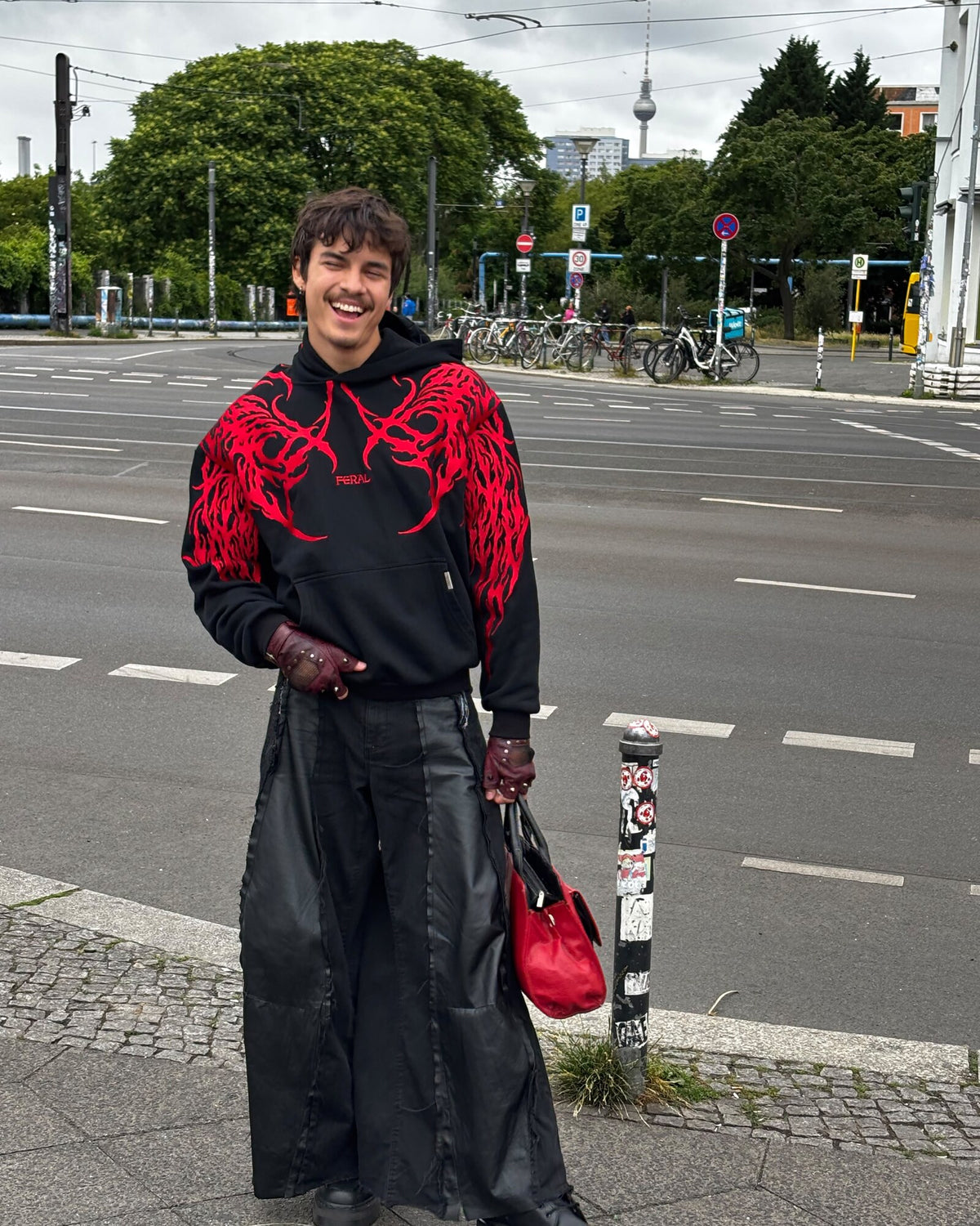 Devour red sigil hoodie on a Berlin street