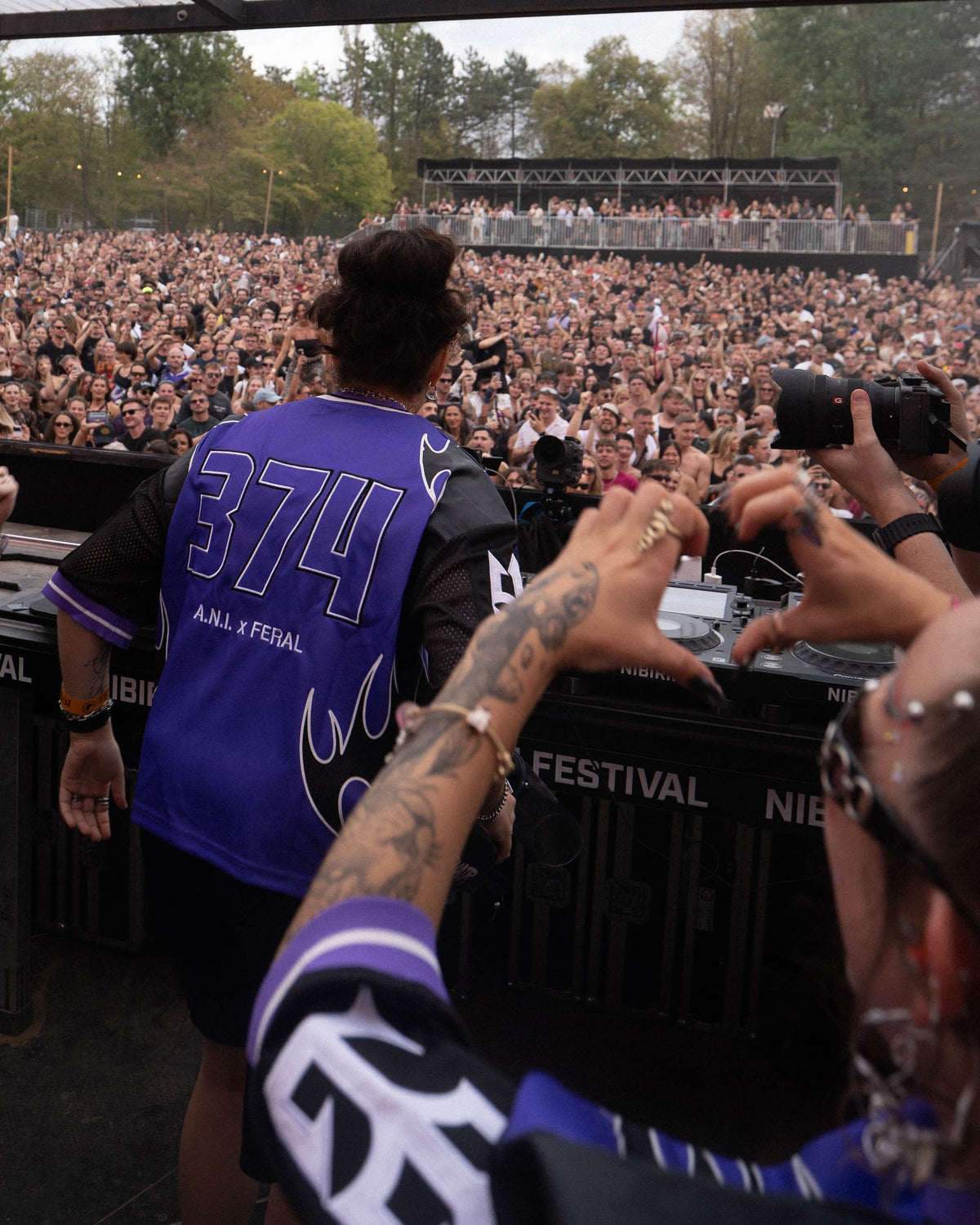 A.N.I. (wears L) DJing at Nibirii Festival in the A.N.I. x FERAL Jersey Purple, back with 374