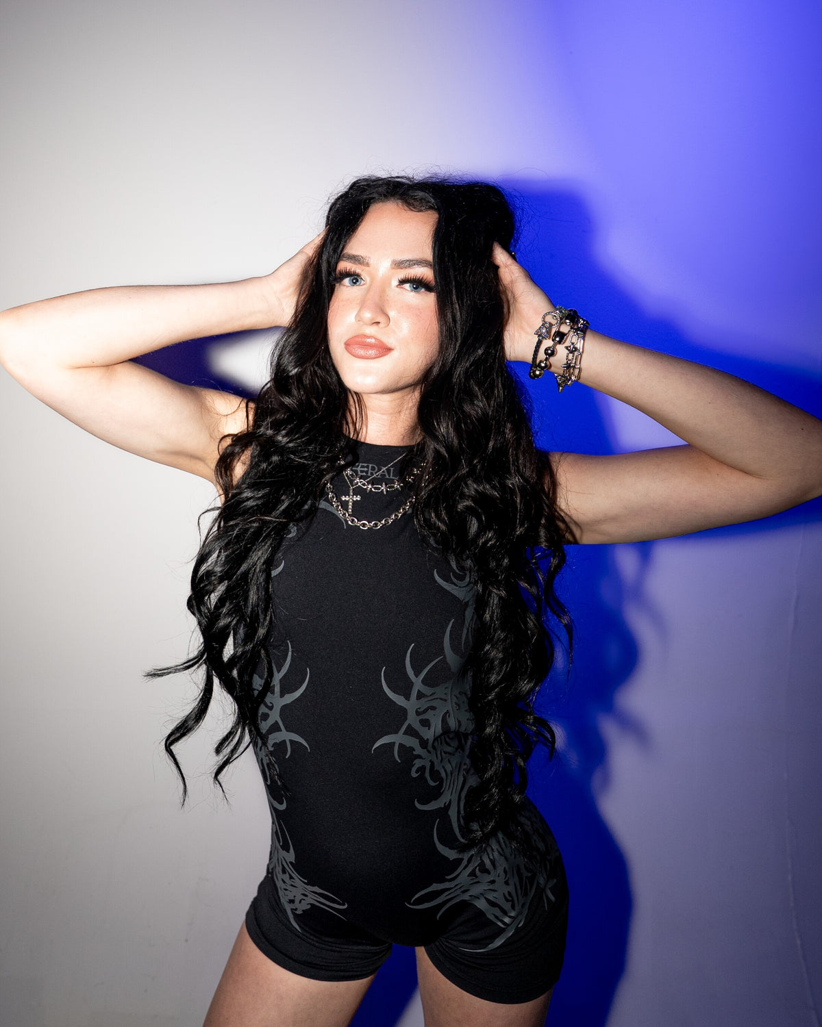 FERAL Black Sigilism One-Piece Romper, front, worn against a white and blue studio wall