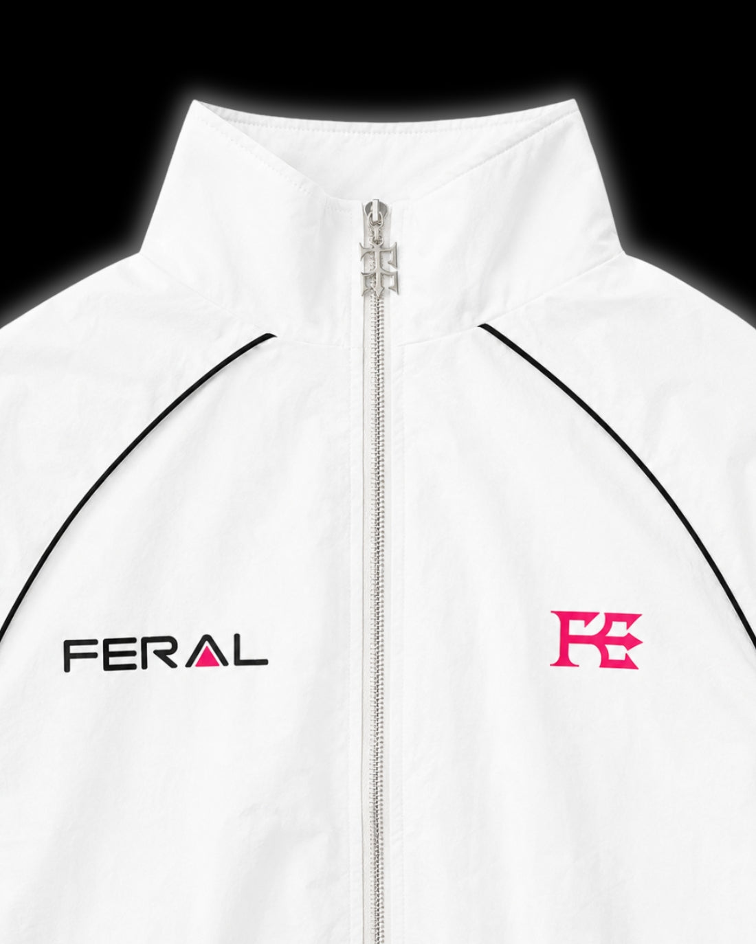 TRIBAL RACER WINDBREAKER pink close-up chest detail custom Feral hardware zip pull FERAL wordmark F monogram black piping high funnel collar