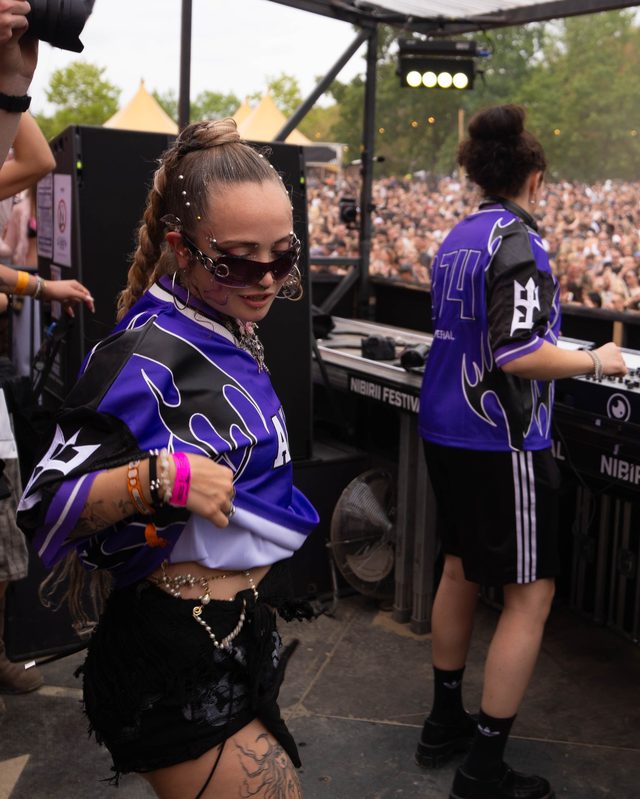 Dancing behind the decks in the purple jersey