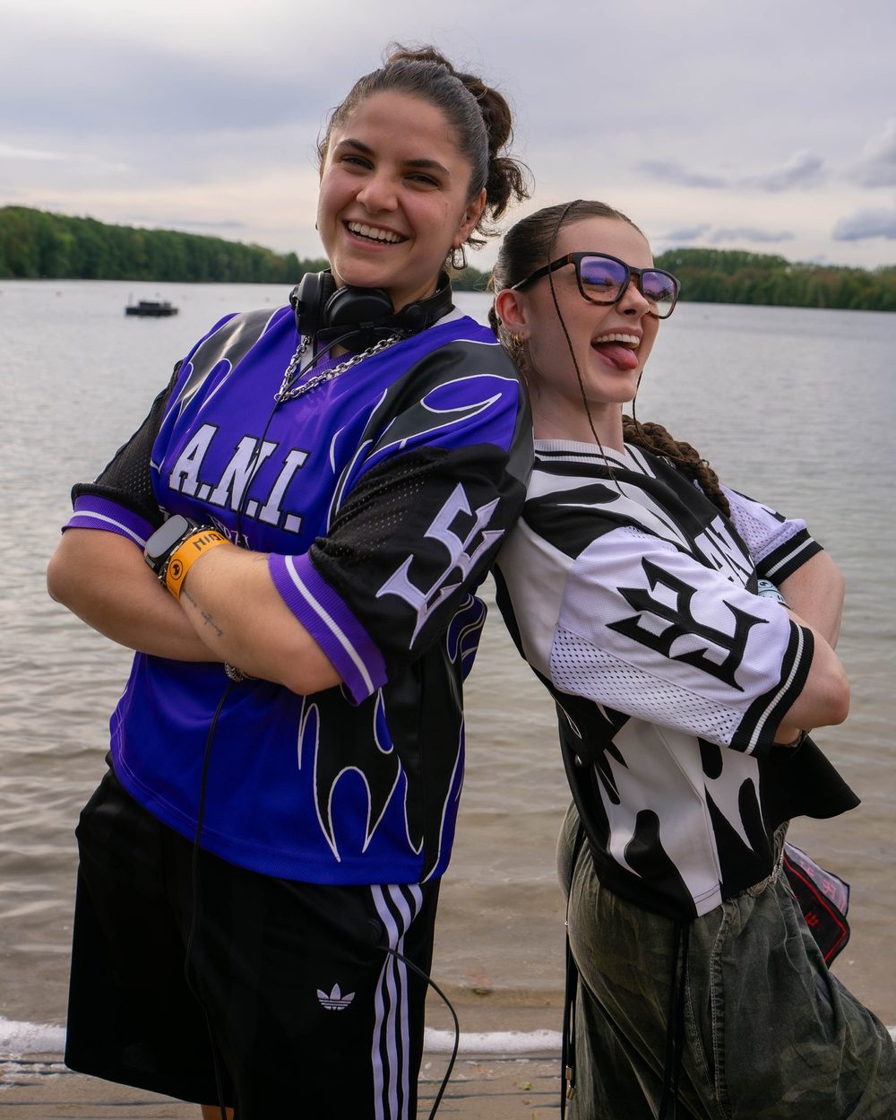 A.N.I. in the purple jersey and Andie in the monochrome, back to back by the lake at Nibirii Festival