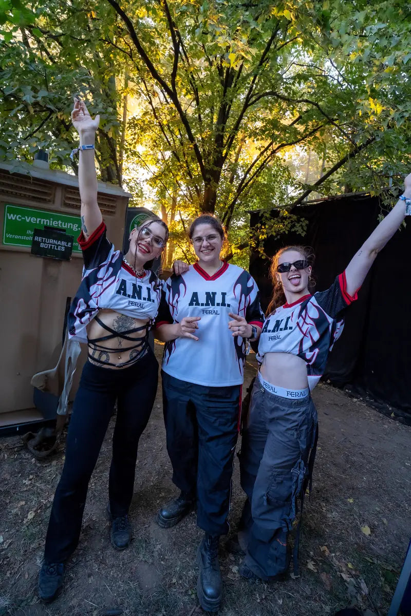 Three people wearing the A.N.I. jersey at Nibirii Festival