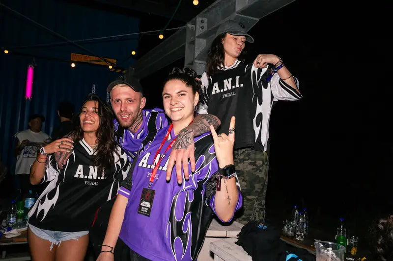 Purple and monochrome A.N.I. jerseys side by side